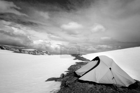 Photo for Climbing tent in high snowy mountains. Turkey, Central Taurus Mountains, Aladaglar (Anti-Taurus), plateau Edigel (Yedi Goller). Black and white toned landscape. - Royalty Free Image