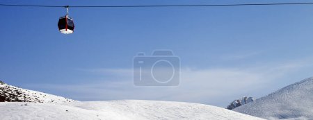 Photo for Panoramic view on gondola lift and snowy ski slope at sun winter day. Caucasus Mountains, Georgia, region Gudauri. - Royalty Free Image