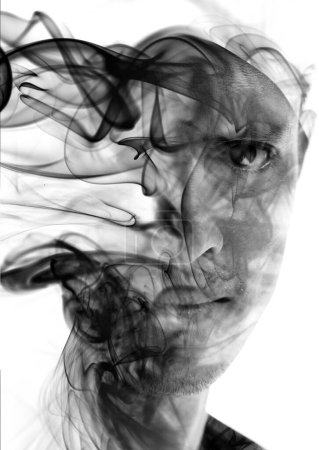 Photo for An artistic balck and white portrait of a mans face combined with smoke swirls in double exposure technique - Royalty Free Image