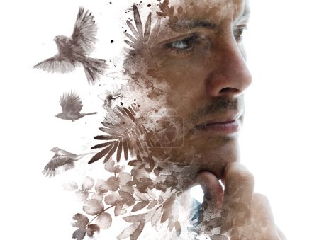 Photo for A conceptual portrait of a man thinking combined with a painting of foliage and flying birds in a paintography technique - Royalty Free Image