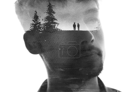 Photo for A black and white conceptual paintography portrait of a young man looking somewhere afar, combined with a painting of a landscape and two figures in double exposure technique - Royalty Free Image