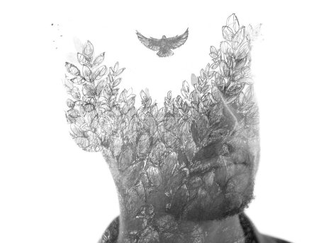 Téléchargez les photos : Portrait noir et blanc d'un jeune homme combiné à une peinture d'un oiseau volant au-dessus des feuilles d'arbre dans une technique de double exposition, créant un concept unique - en image libre de droit