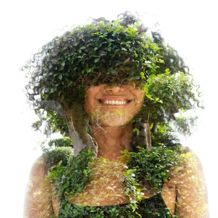 Photo for A portrait of a young smiling girl with frizzy hair in full front combined with a photo of green leaves, and stems in double exposure. - Royalty Free Image