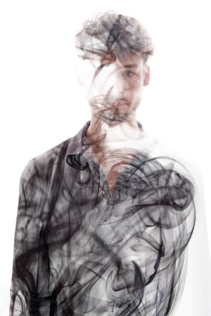 Photo for A full-front portrait of a young man in a dark shirt merged with smoke swirls texture in a double exposure technique - Royalty Free Image