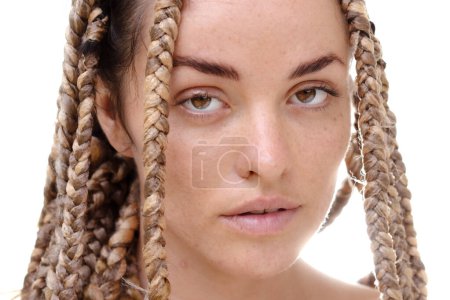 Photo for A closeup portrait of a young woman with dreadlocks looking intently into the camera - Royalty Free Image