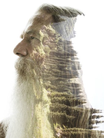 A profile portrait of an old man with a beard and moustache merged with a photo of nature in double exposure