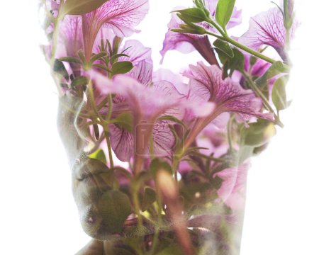 Photo for A closeup portrait of a man looking to the side merged with a closeup photo of flowers in a beautiful double exposure - Royalty Free Image