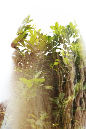 A profile of an old bearded man. Merged with a photo tree leaves in a double exposure disappearing into a white background at the top.