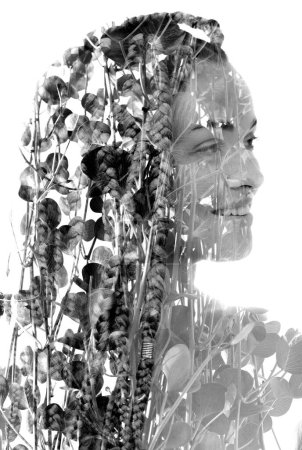 Photo for A black and white half profile portrait of a smiling woman with dreadlocks merged with a photo of foliage in double exposure - Royalty Free Image