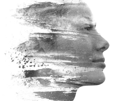 Photo for A closeup profile portrait of a young woman merging into a brush ink strokes in paintography technique - Royalty Free Image