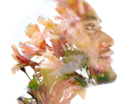 Photo for A profile portrait of a young smiling man disappearing into a photo of flowers in a double exposure - Royalty Free Image