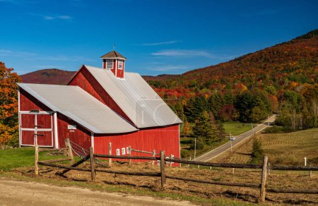 Photo for Grandview farm barn by the side of the track near Stowe in Vermont during the autumn color season - Royalty Free Image