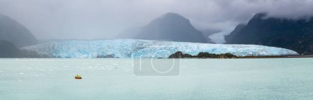 Photo for Panorama with crew in small power boat collecting iceberg by Amalia Glacier in Patagonia - Royalty Free Image