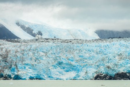 Photo for Milky light blue ocean by Amalia glacier with detail of the fissures and rocks in its path - Royalty Free Image