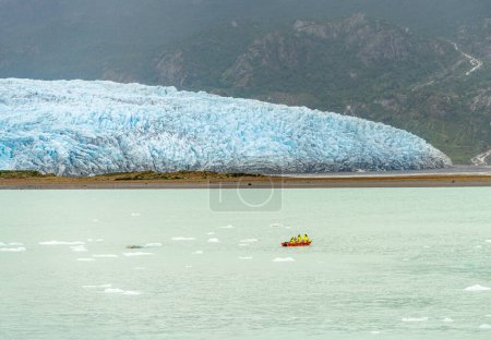 Photo for Crew in small power boat collecting iceberg by Amalia Glacier in Patagonia and Chile - Royalty Free Image