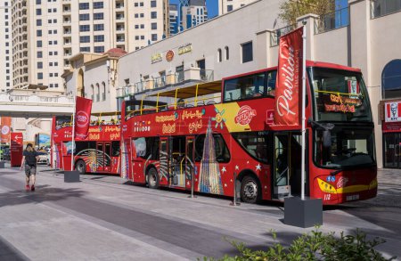 Photo for Dubai, UAE - 3 April 2023: Red city sightseeing bus for hop on hop off tour of the city - Royalty Free Image