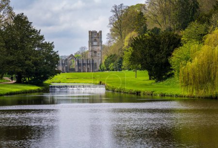 Detail of the ruins of Fountains Abbey in Yorkshire, United Kingdom in the spring with River Skell flowing past
