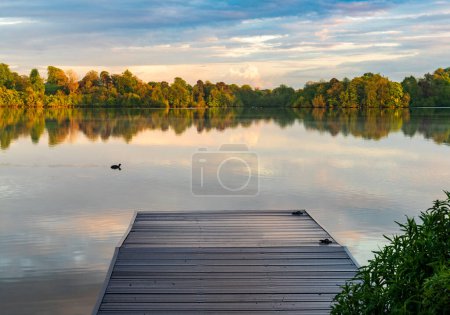 Photo for Sunset panorama of the lake shore of the Mere with a perfect lake reflection in Ellesmere in Shropshire - Royalty Free Image