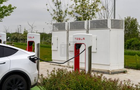 Photo for Midlands, UK - 13 May 2023: Tesla electric car charging points on motorway - Royalty Free Image