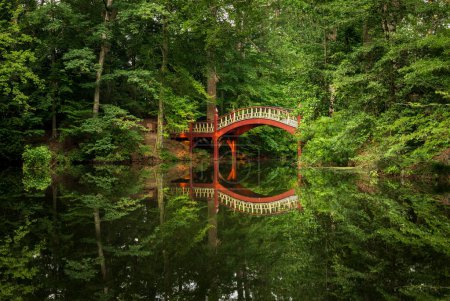 Photo for Ornate wooden bridge over very calm Crim Dell pond on campus of William and Mary college in Williamsburg Virginia - Royalty Free Image