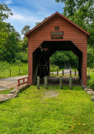 Photo for Dents Run Covered Bridge is a historic covered bridge located near Laurel Point, Monongalia County, West Virginia. Kingpost truss construction in 1889 - Royalty Free Image