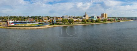 Photo for Davenport, IA - 18 October 2023: Panorama of Modern Woodmen Park stadium with downtown Davenport along Mississippi River in Iowa - Royalty Free Image