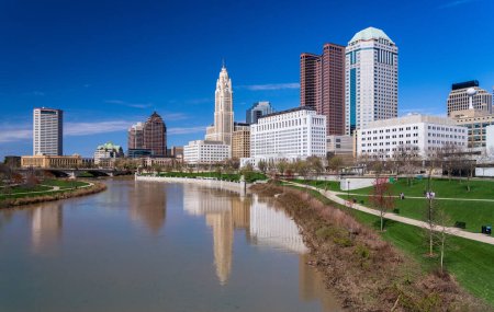 Photo for Columbus ohip waterfront view of the downtown financial district from the River Scioto after a flood over the park - Royalty Free Image