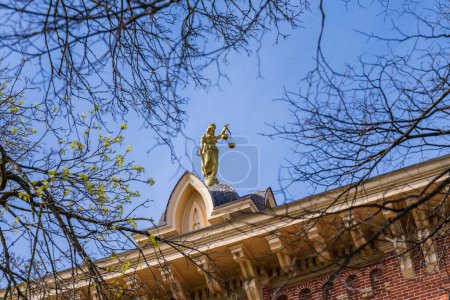 Photo for Lady Justice or Iustitia on the roof of the Delaware County Courthouse in Delaware, OH - Royalty Free Image