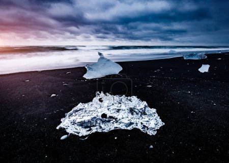 Photo for Large pieces of the iceberg that sparkle on the black sand. Popular tourist attraction. Location famous place Jokulsarlon lagoon, Vatnajokull national park, island Iceland, Europe. Beauty world. - Royalty Free Image