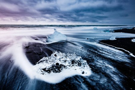 Photo for Large pieces of the iceberg that sparkle on the black sand. Picturesque and gorgeous scene. Location famous place Jokulsarlon lagoon, Vatnajokull national park, south Iceland, Europe. Beauty world. - Royalty Free Image