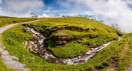 Photo for Great view of alpine misty hills and glacier stream. Picturesque and gorgeous scene. Location place Swiss alps, Grindelwald valley, Bernese Oberland, Europe. Discover the world of beauty. - Royalty Free Image