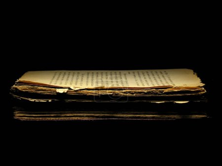 Photo for Old shabby book isolated over a black background. Historical museum exhibit. Cross process filter, retro and vintage style. Instagram toning effect. - Royalty Free Image