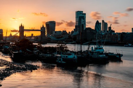 Photo for Tower bridge and London skyline view at sunset - Long exposure hdr view of boats on the Thames river with famous landmarks on background - travel and architecture - Royalty Free Image