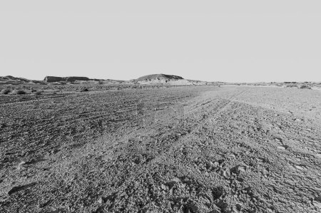 Téléchargez les photos : Paysage à couper le souffle des formations rocheuses dans le désert d'Israël en noir et blanc. Scène sans vie et désolée comme concept de solitude, de désespoir et de dépression. - en image libre de droit