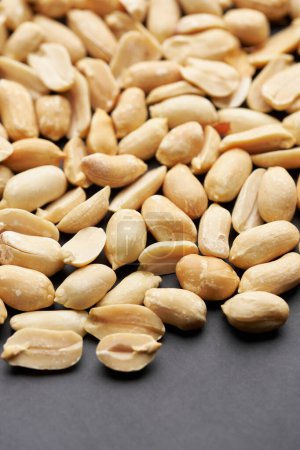 Whole shelled peanut nuts kernels close-up studio background.