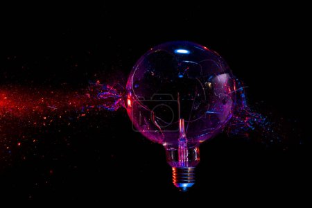 Photo for Large filament bulb breaks and creates fragments. black background. - Royalty Free Image