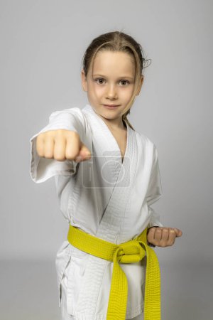 Photo for Caucasian girl practises karate, studio shot - Royalty Free Image