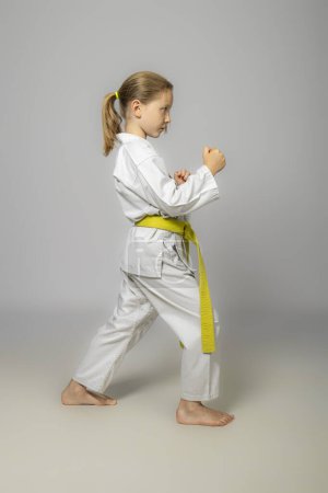 Photo for Child practises martial arts, studio shot - Royalty Free Image