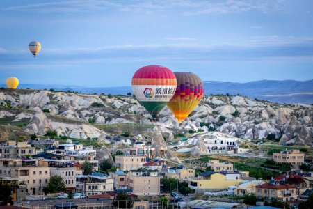 Photo for GOREME TURKEY - June 27, 2022: hot air balloons fly low over the city of goreme at sunrise - Royalty Free Image