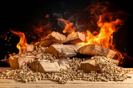 Photo for Wood pellets and logs with flames in the background - Royalty Free Image