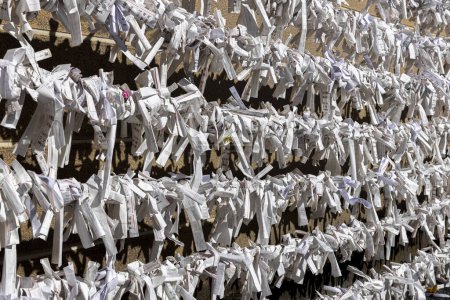 Photo for Omikuji knotted on a rope inside a temple in japan - Royalty Free Image