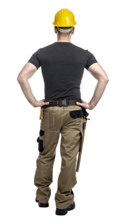 Téléchargez les photos : Ouvrier de la construction homme debout avec confiance avec les mains sur les hanches, isolé sur fond transparent, vue de dos - en image libre de droit