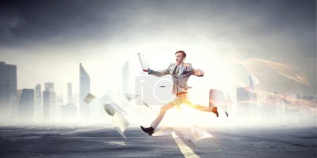 Photo for Portrait of energetic businessman jumping in open air. Mixed media - Royalty Free Image