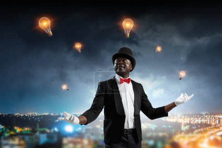 Photo for Male illusionist performing tricks. mixed media - Royalty Free Image