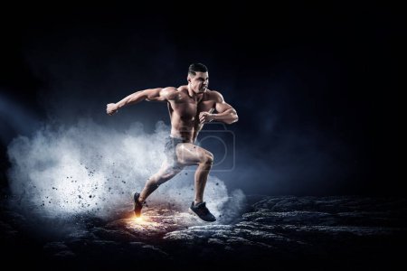 Photo for Male runner against dark background. Mixed media - Royalty Free Image