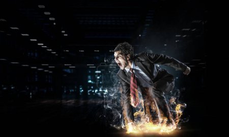 Photo for Determined businessman leaving fire trails on asphalt. Mixed media - Royalty Free Image