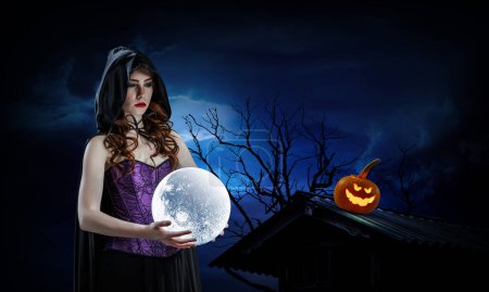 Photo for Beautiful young woman in witches hat and costume. Halloween art design. Mixed media - Royalty Free Image
