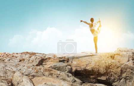 Photo for Young beautiful girl wearing fashion sports wear doing exercise. Mixed media - Royalty Free Image