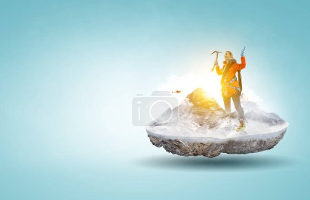 Photo for Mountaineer reaches the top of a snowy mountain. Mixed media - Royalty Free Image