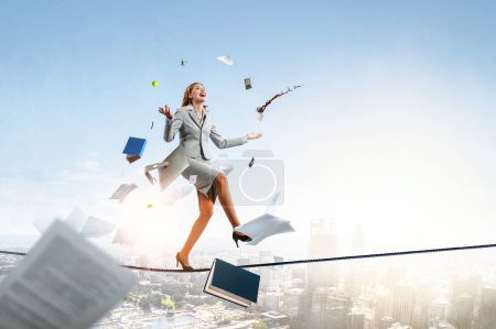 Photo for Young pretty businesswoman juggling with business items. Mixed media - Royalty Free Image
